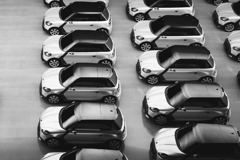 A collection of grey fleet cars parked in lines